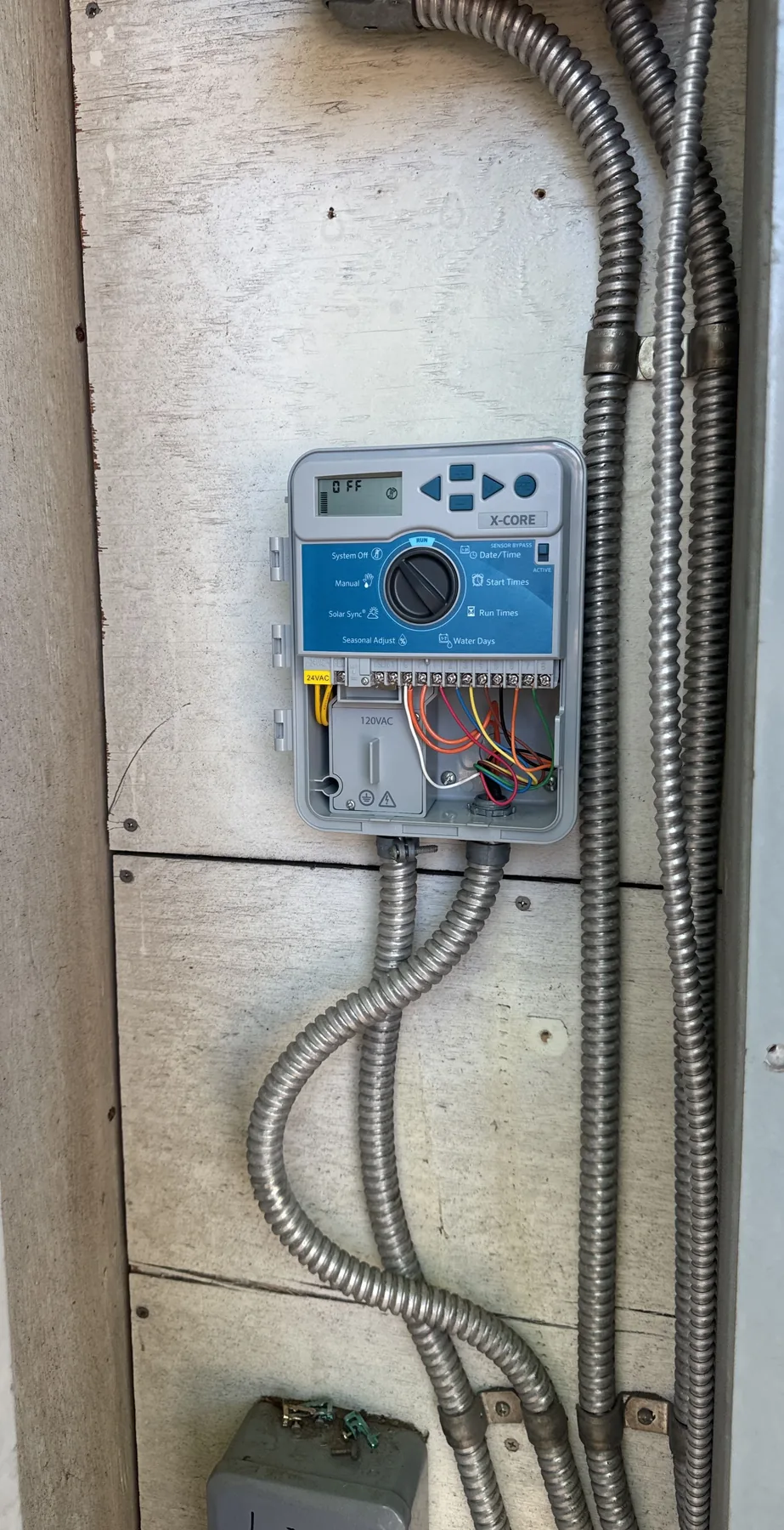 Open irrigation controller with visible system wiring
