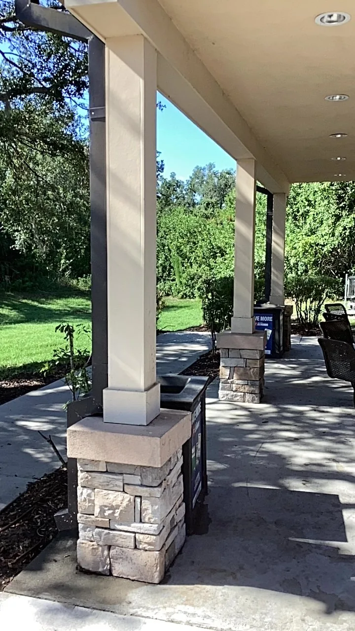Shaded residential lawn viewed from a covered porch