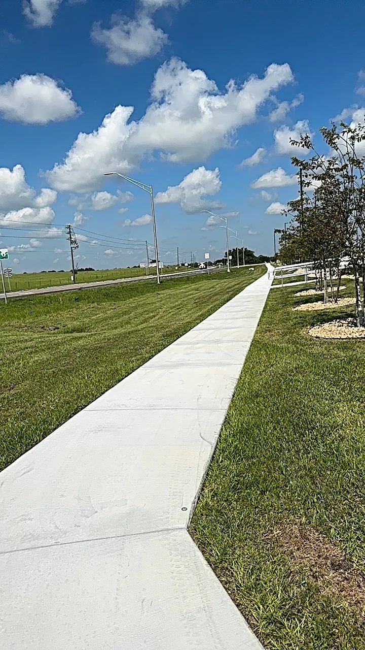 Long stretch of commercial lawn beside a sidewalk