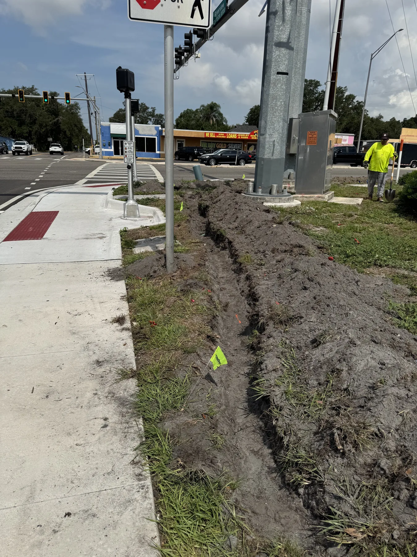 Irrigation trench under construction along a city sidewalk
