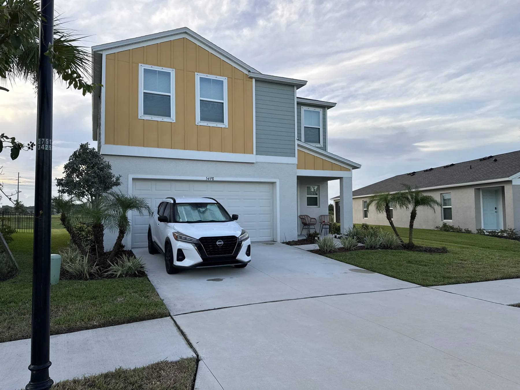 Trim residential lawn surrounding a two-story home
