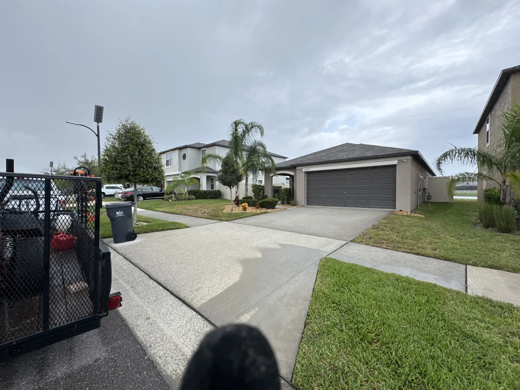 Lawn-maintenance trailer positioned beside a residential property