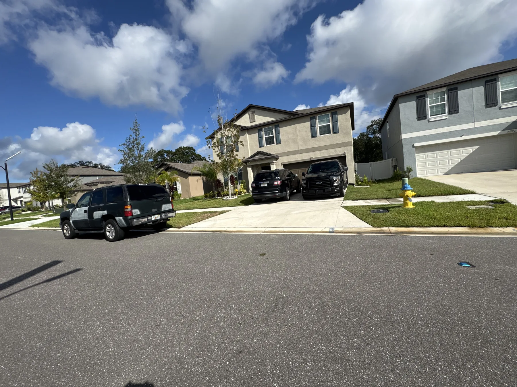 Broad front lawn across a two-story residential property