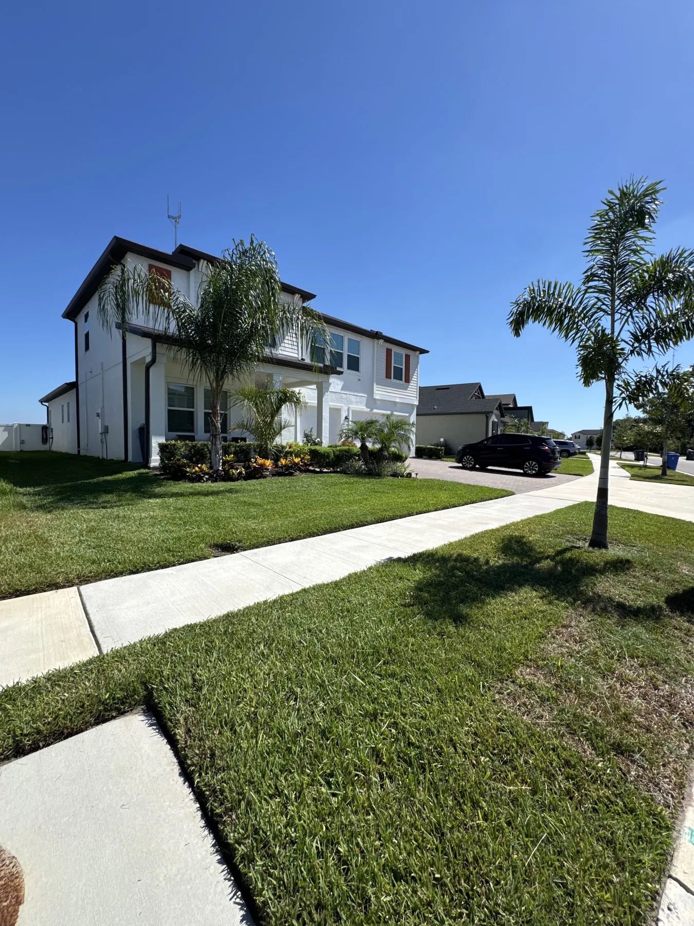Modern two-story home with clean lawn and landscape beds